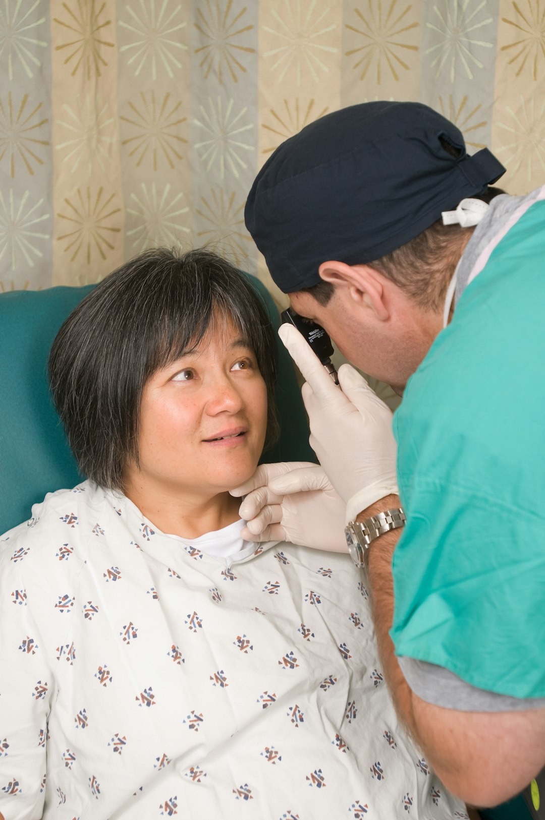 An ophthalmologist examining a patient's eye with an ophthalmoscope
